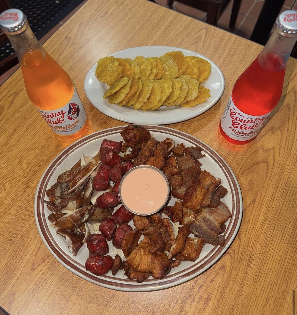 Fritura platter with tostones and Country Club sodas