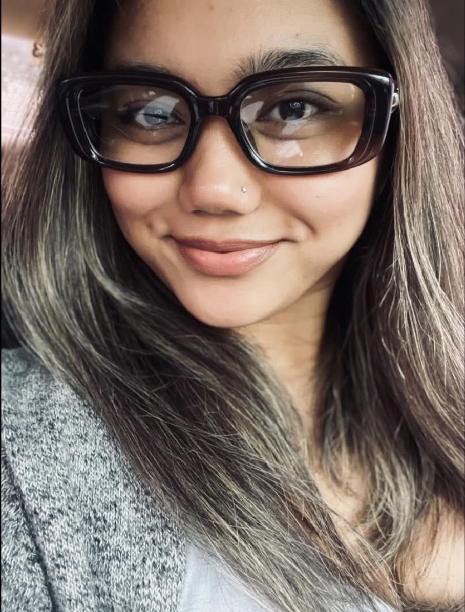 Angie smiling, in oversized glasses