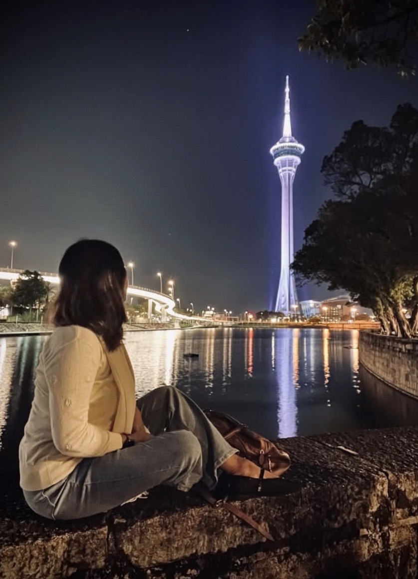 Angie at Macau Tower at night, by the water