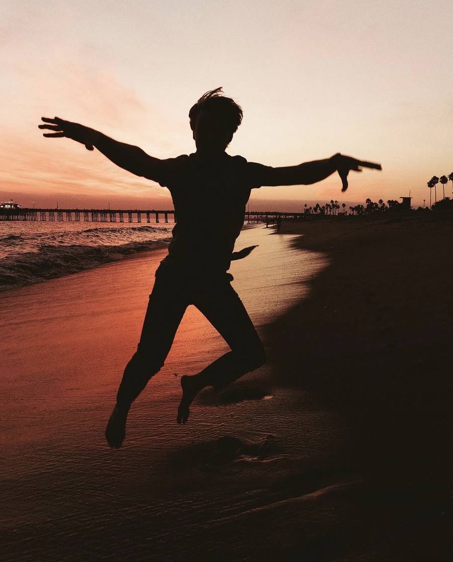 Silhouette jumping on a beach at sunset