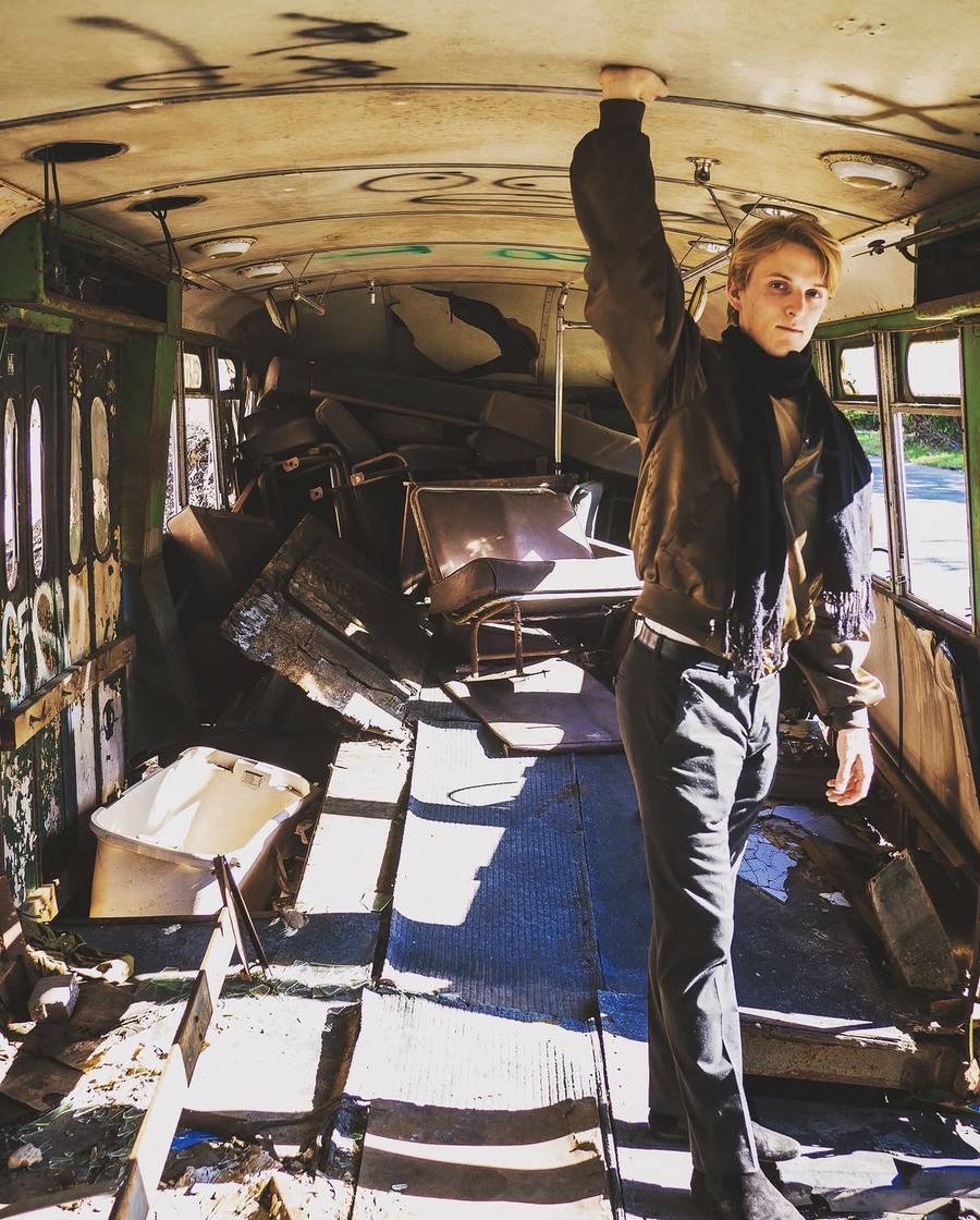 Standing in an abandoned graffitied bus